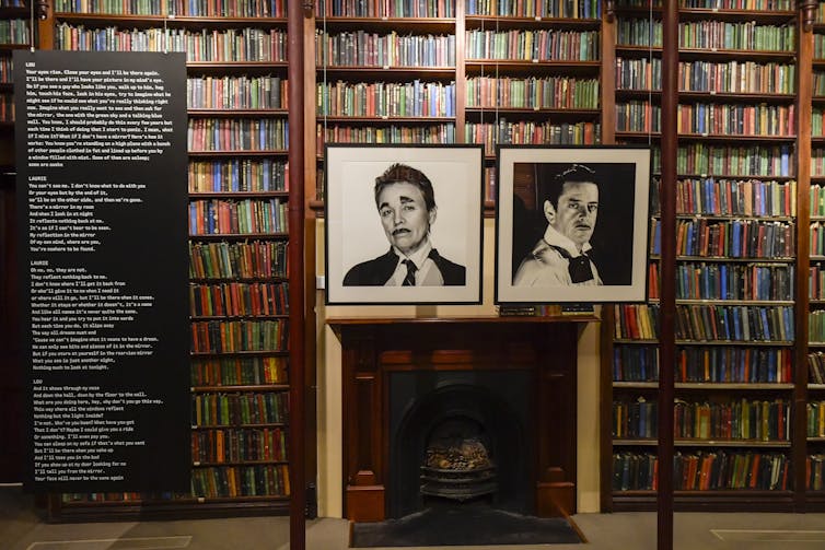 A large text and two portrait photographs inside a library.