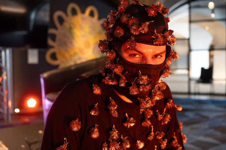 A man covered in golden flowers.