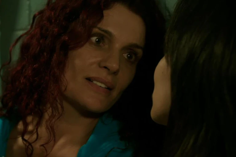 Two women face each other in a scene from a television show