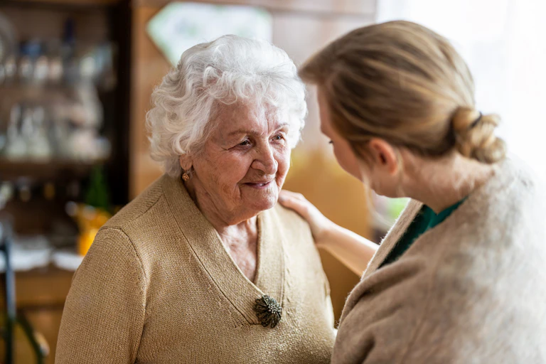 Aged care resident smiles at visitor