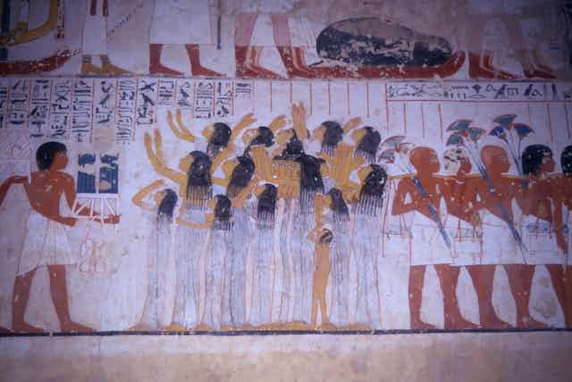 An ancient Egyptian mural shows a scene from a funeral