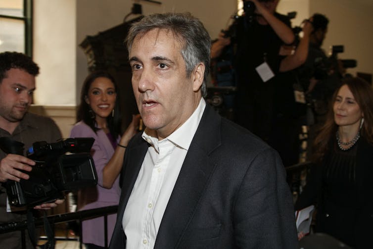 A man in a suit leaves a courtroom