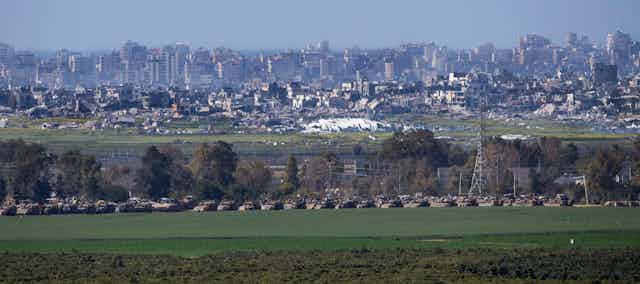 Israeli tanks wait at a staging post on the border with the Gaza Strip, March 11 2024.
