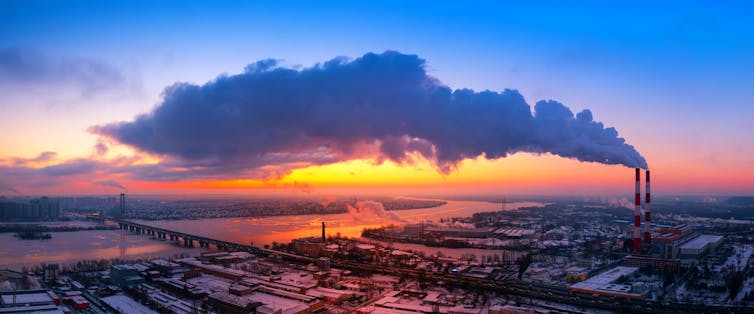 Huge cloud above city coming from large industrial chimney