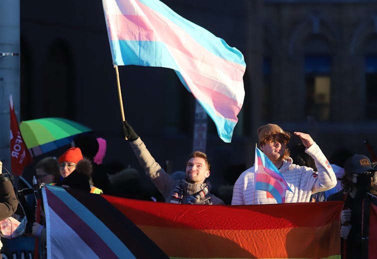 Protesters with transgender pride flags
