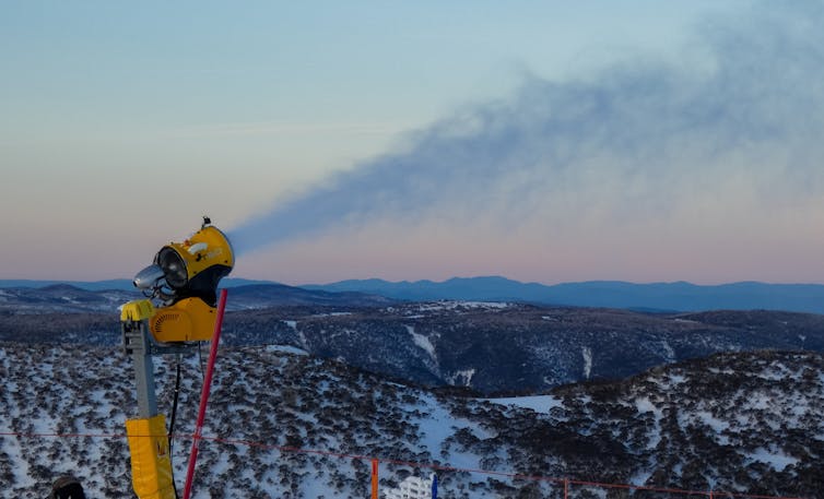 A snow machine shoots out a plume of snow in the Snowy Mountains
