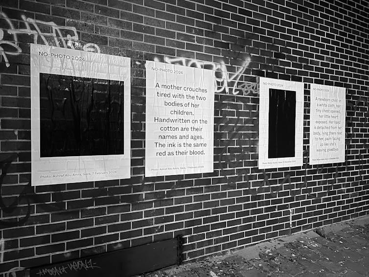 Posters on a brick wall.