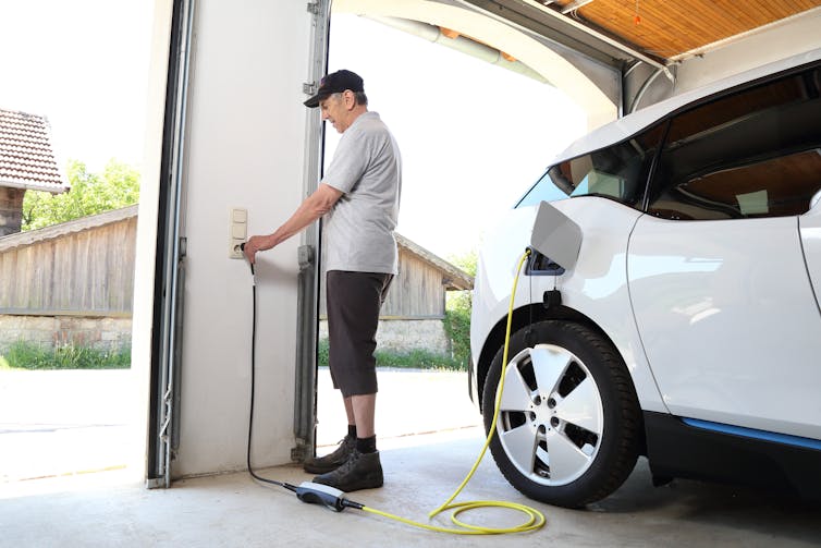 man charging his EV at home