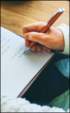 Photo of elder writing a letter