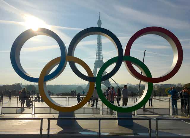Olympic games symbol in front of the Eiffel Tower.