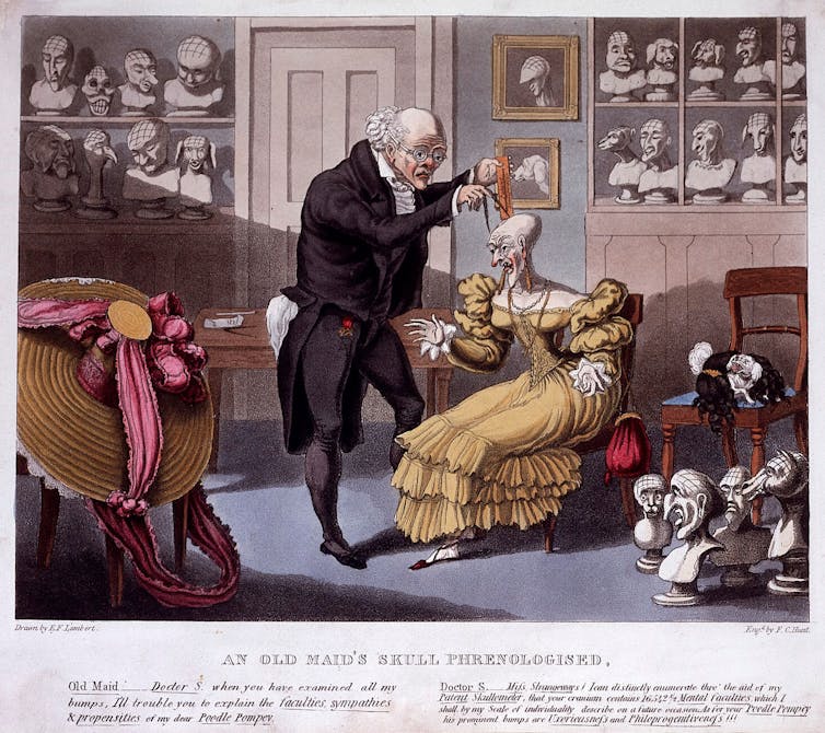 Illustration of Franz Joseph Gall, the founder of phrenology, measuring the head of a bald, elegantly dressed old lady; her pet poodle is entwined in her wig on a chair.