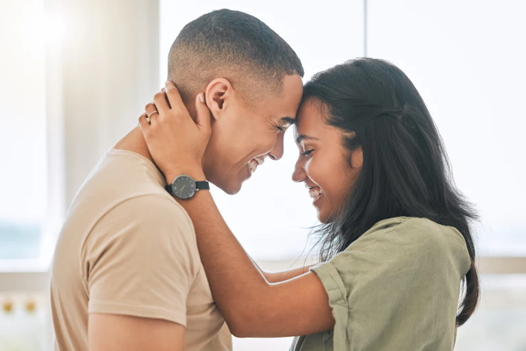 Couple embracing looking at each other smiling