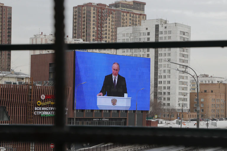 A big screen in a street showing Vladimir Russia.