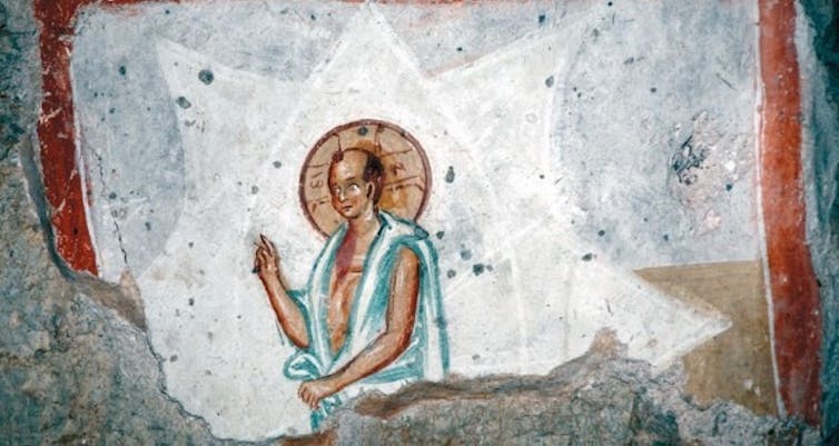 Fresco painting of a balding Jesus with a halo.