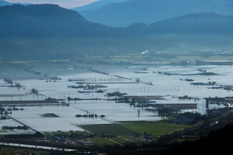 Flooded fields and roads are seen from the air.