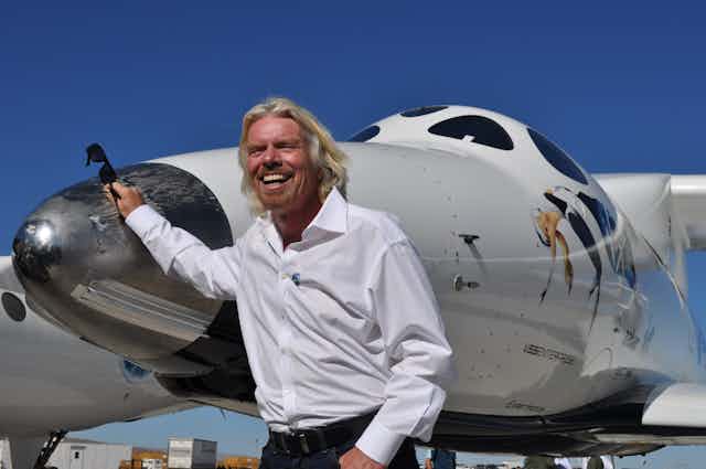 Richard Branson, next to White Knight Spaceship 2.