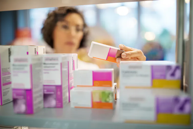 Chemist examining different medicines.