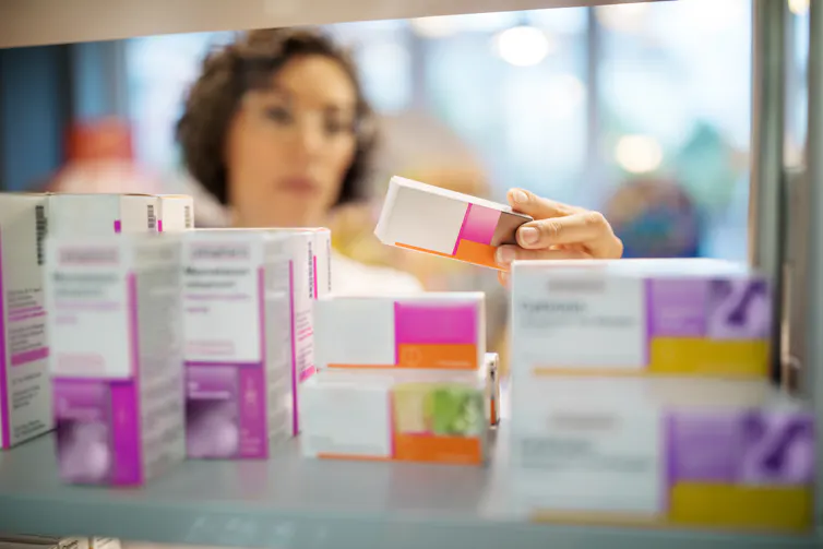 Chemist examining different medicines.