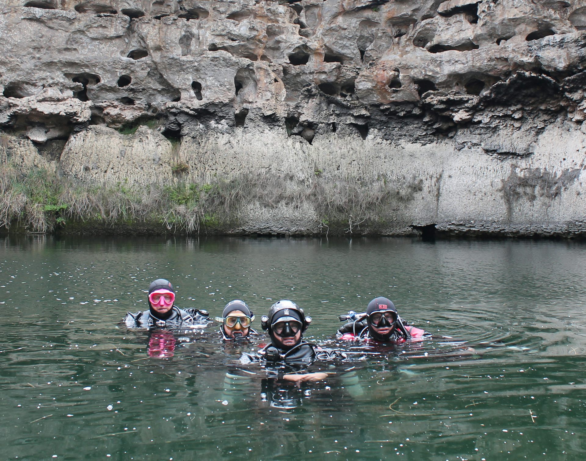 A group of divers on the surface of Tank Cave, about to dive.