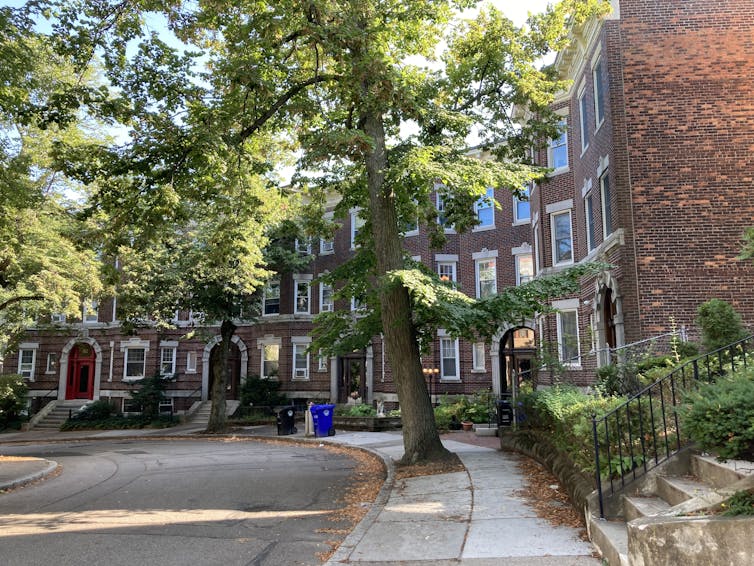 A row of brick townhouses lining a cul-de-sac