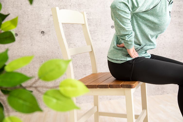 Woman sits on chair