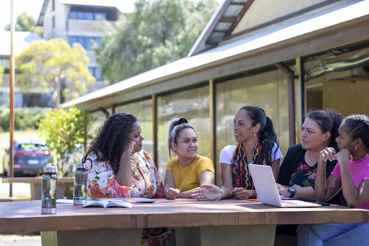 A group of Aboriginal women sitting together around a table