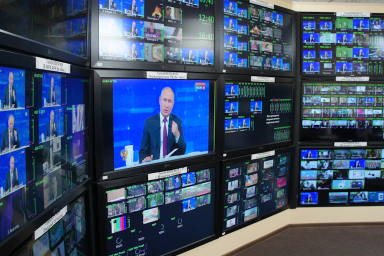 A wall of screens all showing the Russian president, Vladimir Putin.