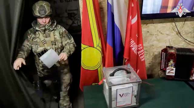 A Russian solcier casts his vote in a Russian-controlled region in eastern Ukraine. 