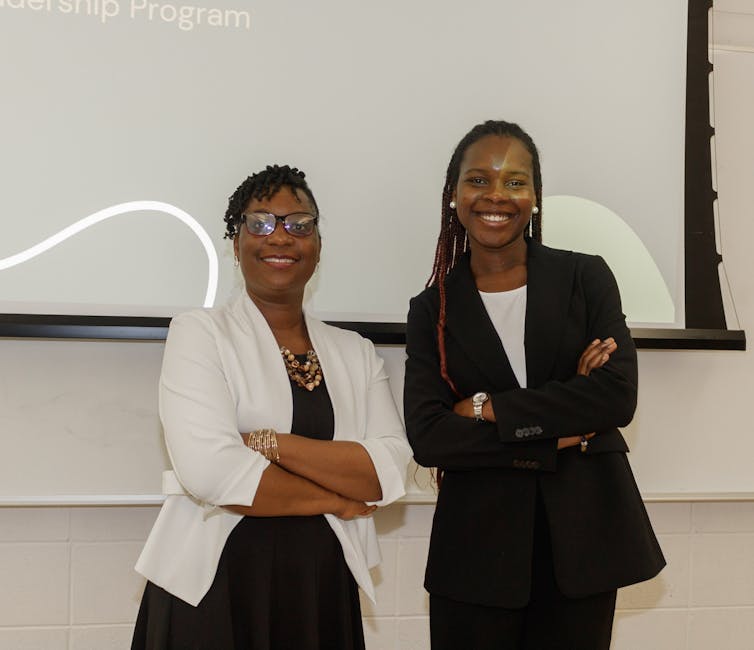 Two women seen smiling.