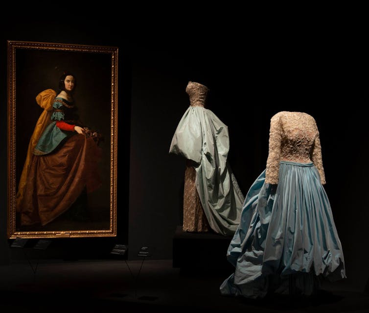 Evening ensemble of cotton tulle dress, metal thread embroidery on rayon satin, and silk taffeta overskirt, designed by Balenciaga, and _St. Isabella of Portugal_ by Francisco de Zurbarán.