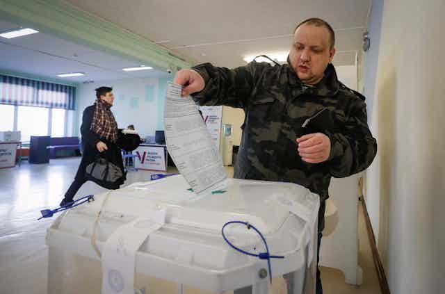 A Russian man casts his ballot in the 2024 presidential elections