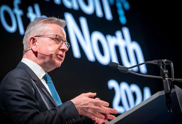 Secretary of State for Levelling Up, Housing and Communities Michael Gove at a podium.