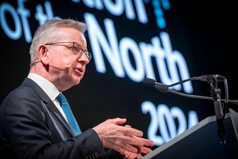 Secretary of State for Levelling Up, Housing and Communities Michael Gove at a podium.