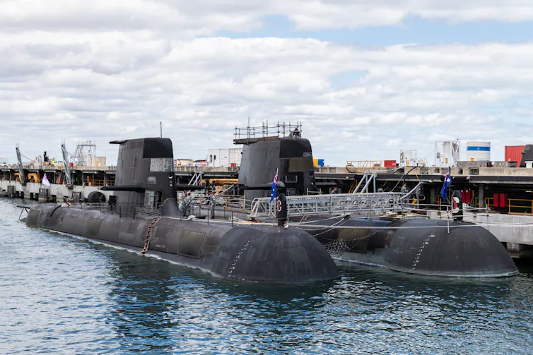 Two submarines in dock.