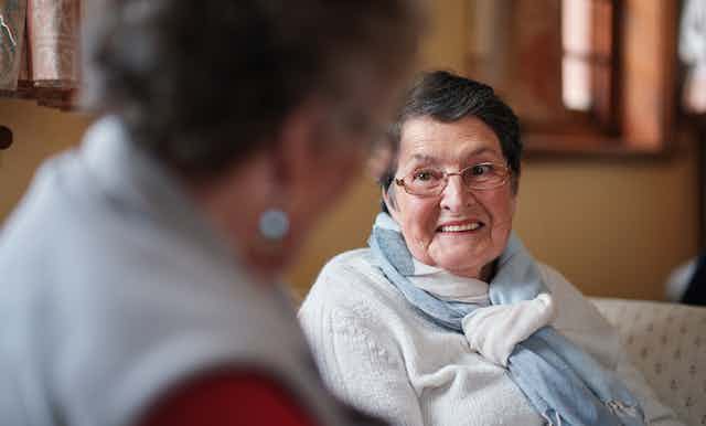 Older person talks to aged care worker