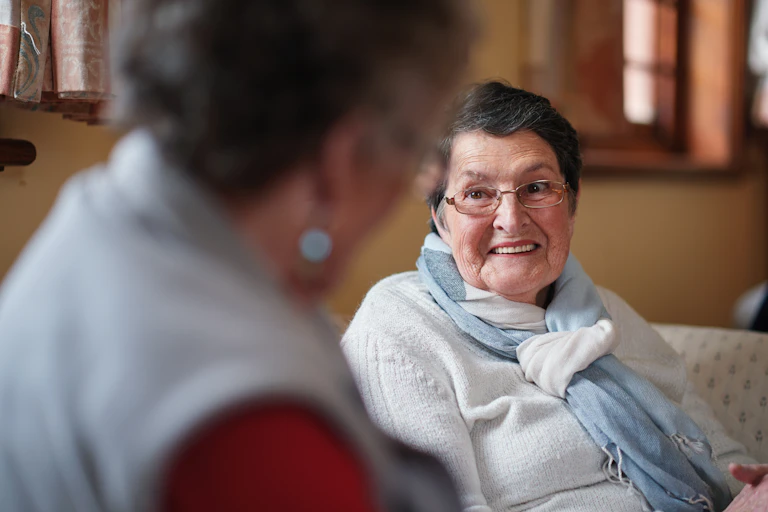 Older person talks to aged care worker