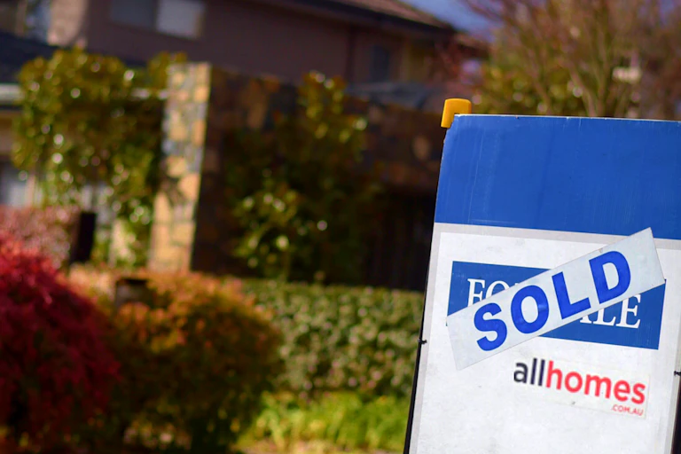 Sign outside house saying "sold"