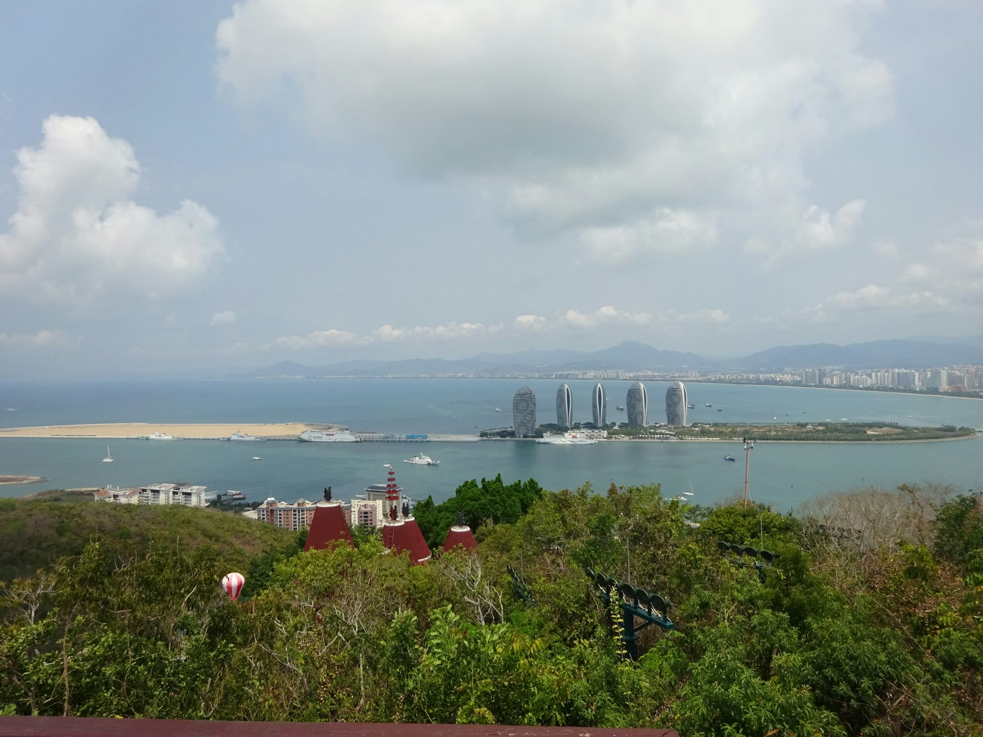 A photograph from a hillside of an island in the distance.