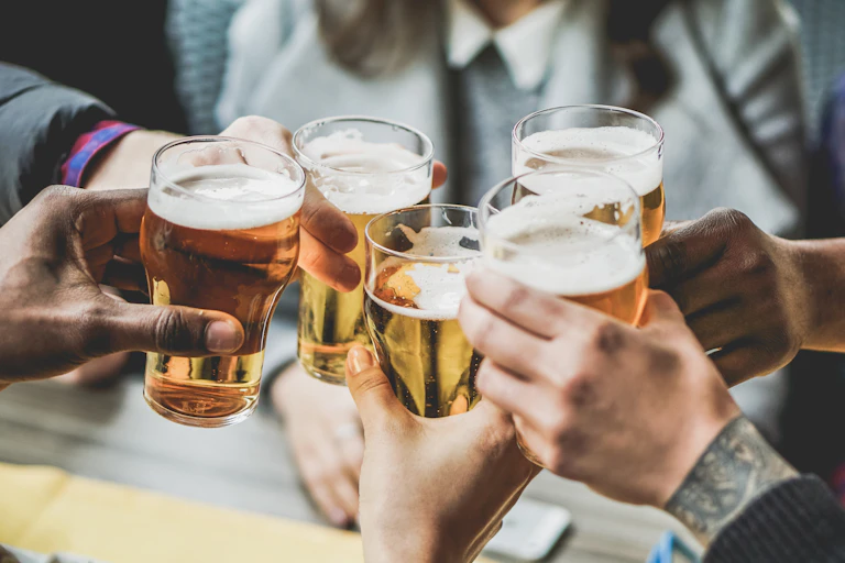 Five beer glasses clinking in a toast