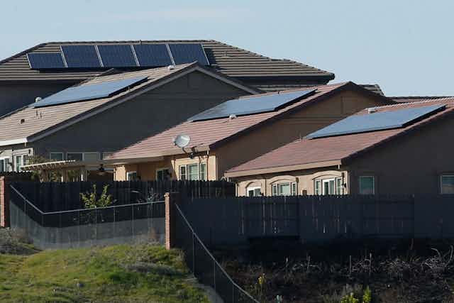 Four homes with solar panels on their roofs