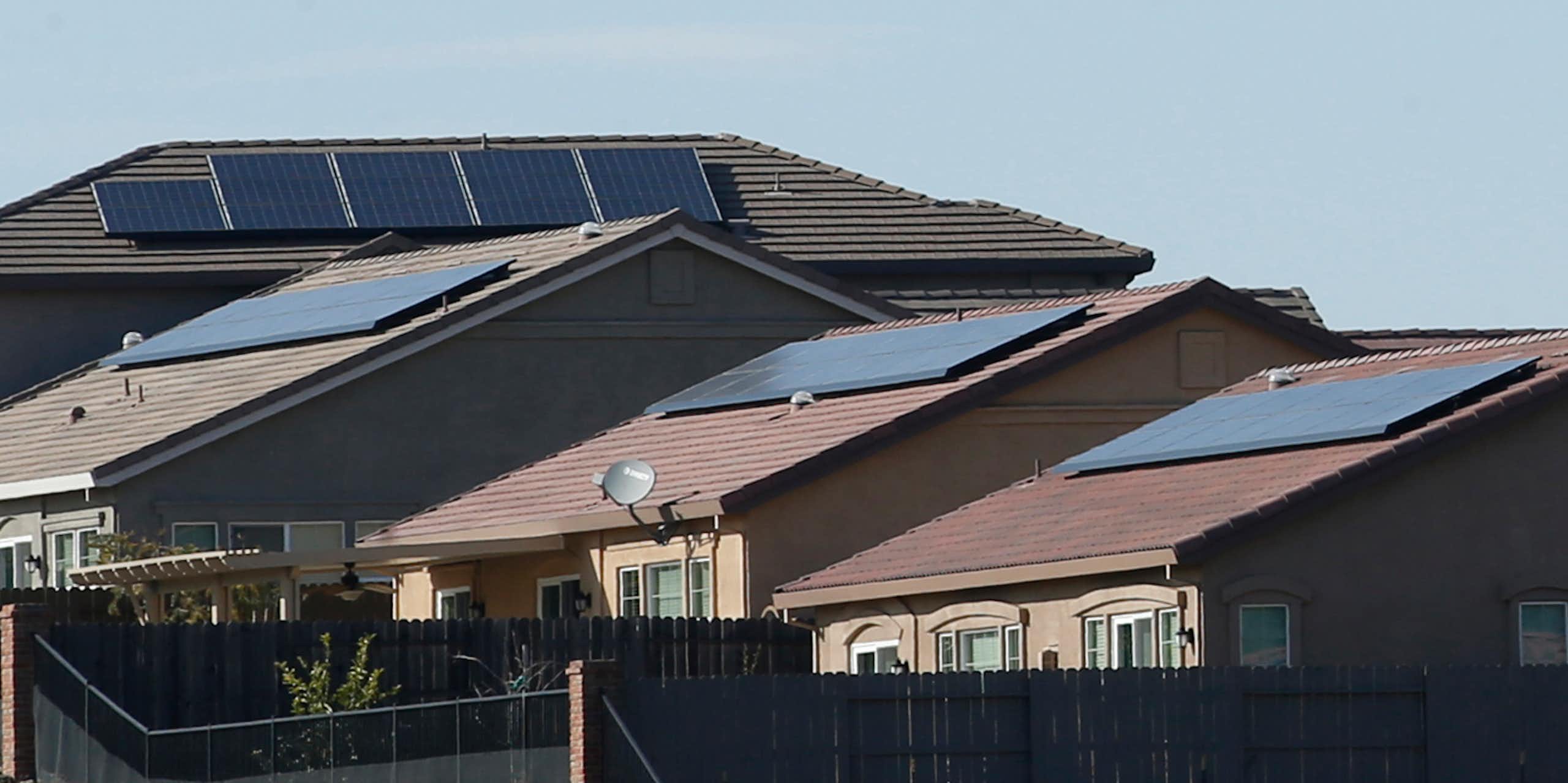 Four homes with solar panels on their roofs