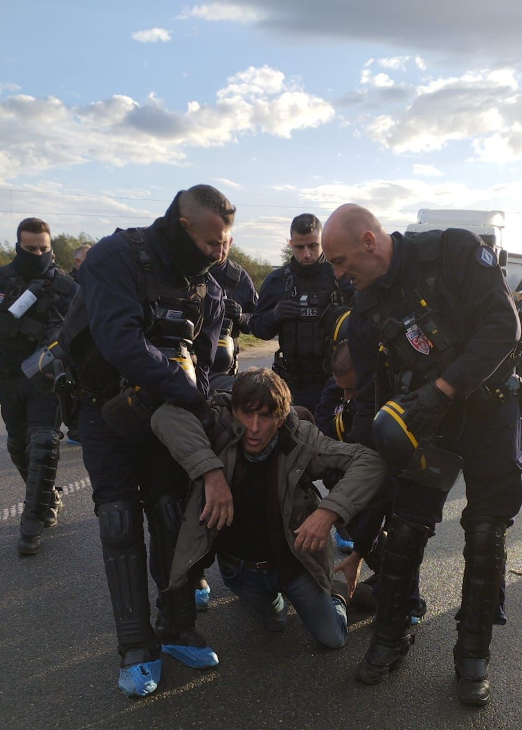 A man is carried away by police.