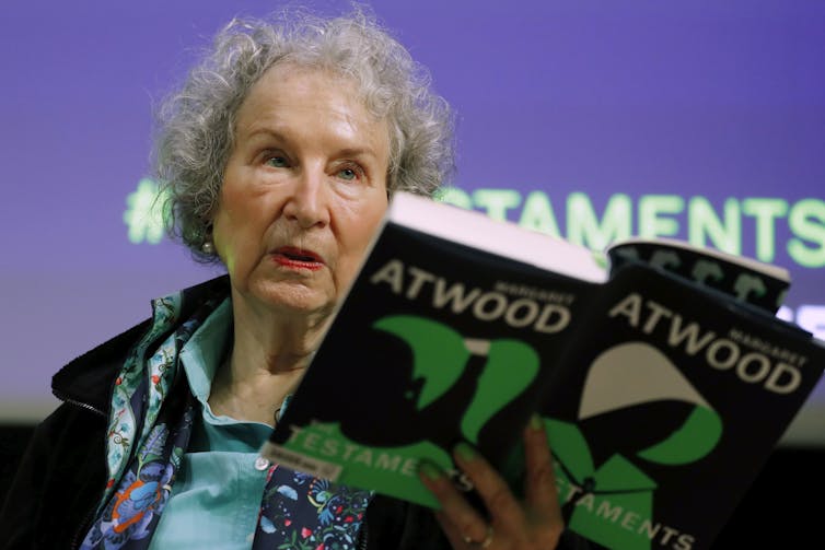 Author Margaret Atwood holding a copy of her book The Testaments.