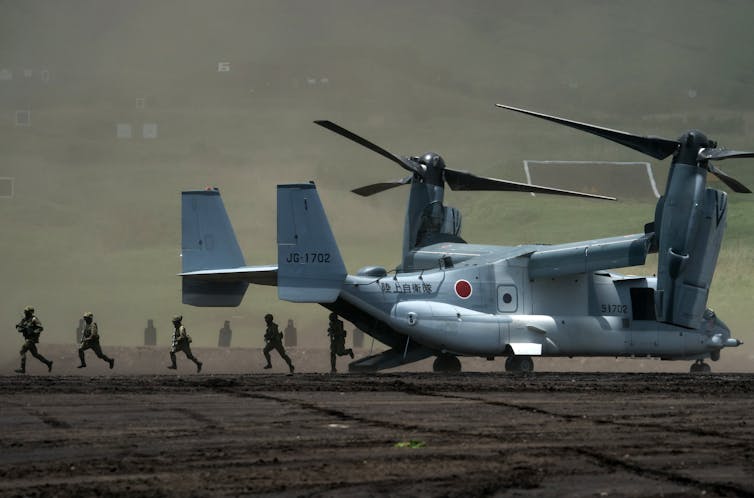 Members of the Japan Ground Self-Defense Force (JGSDF) disembark from a V-22 Osprey aircraft during a live fire exercise at East Fuji Maneuver Area in Gotemba, Japan,  May 2022.