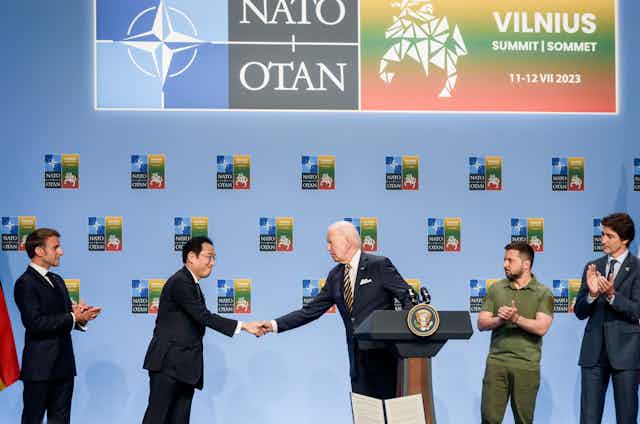 Japanese prime minister Fumio Kishida shakes hands with Joe Biden as Ukrainian president VOlodymyr Zelensky and G7 leaders watchnounce a Joint Declaration of Support to Ukraine , during NATO SUMMIT 2023