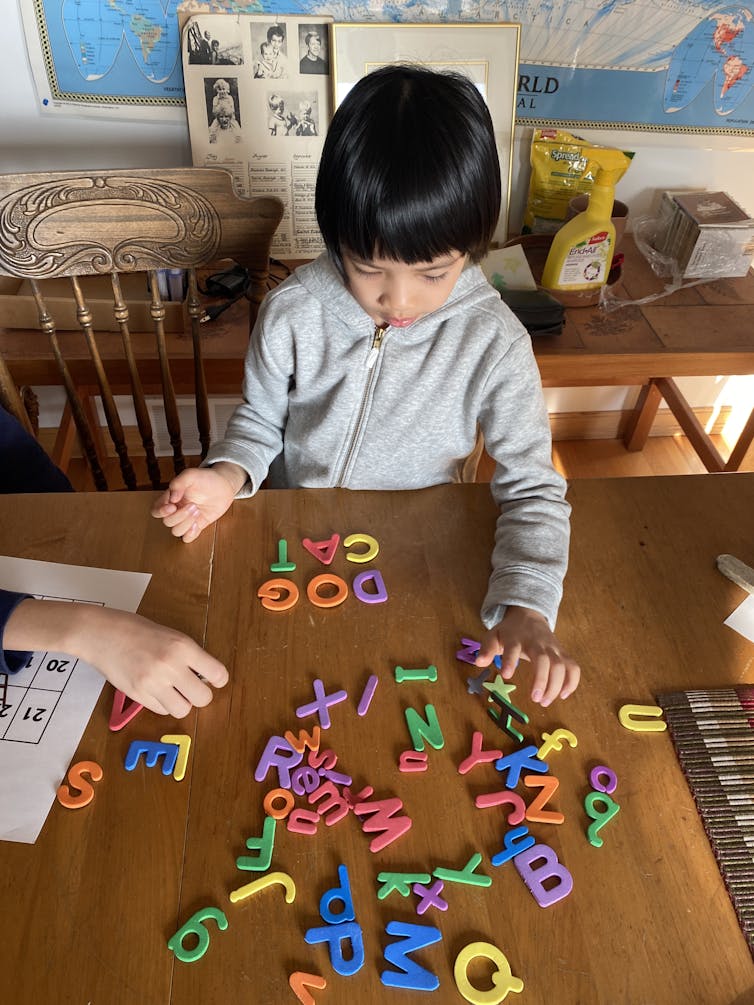 A child touching colourful letters