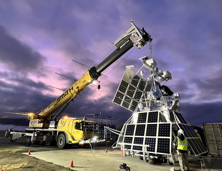 SuperBIT held by a crane for final checks.