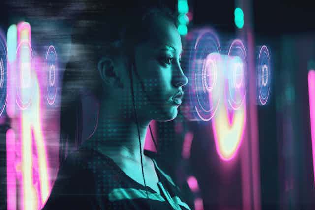 a woman lit by purple and green lights with an overlay of digital circles