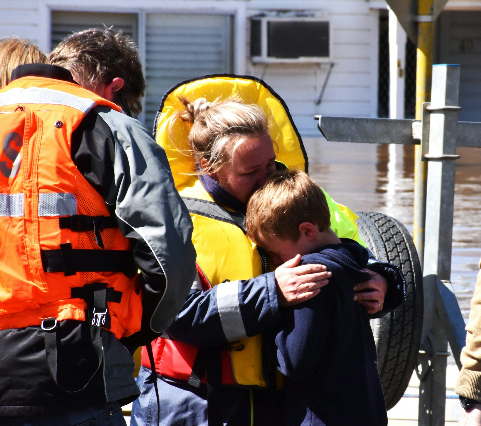 boy is comforted during flood evacuation