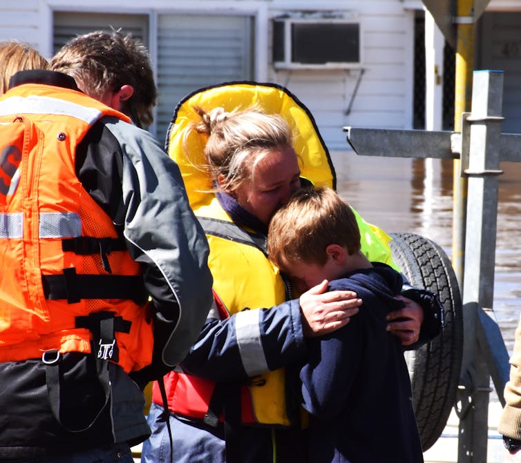 boy is comforted during flood evacuation